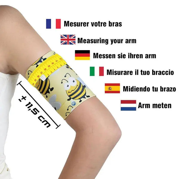 Blood glucose sensor armband for children featuring fauna and flora design, shown on an arm with a measuring tape for size reference.