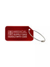 Red luggage tag with the text 'Medical Supply Bag Handle With Care' engraved.