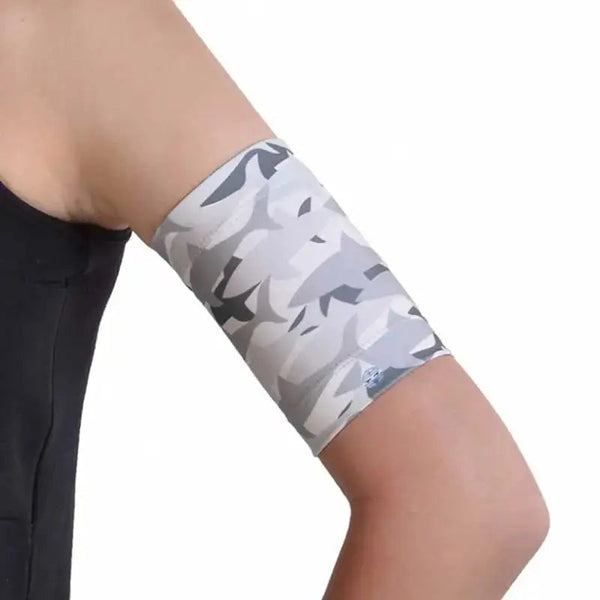 Armband for kids holding glucose sensor and pod with camo design.