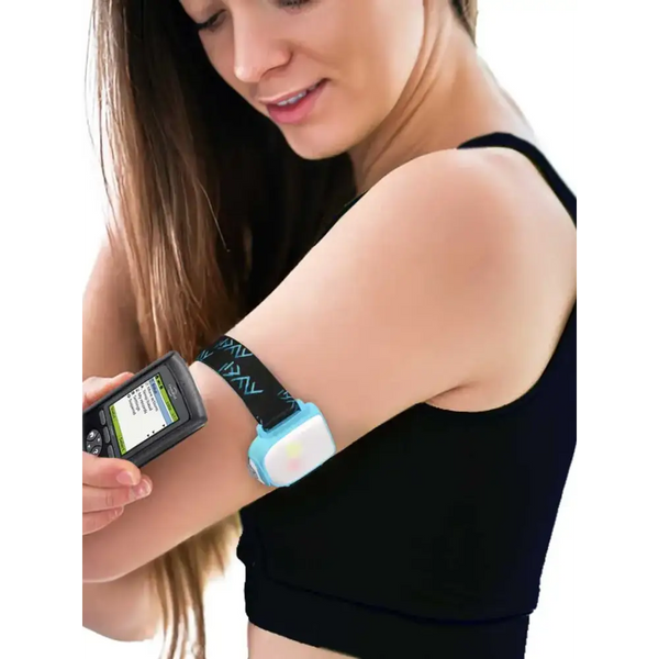 Omnipod insulin patch pump adjustable armband with colored clip in use on woman's upper arm.