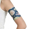 Glucose sensor armband in sea and beach design on upper arm.