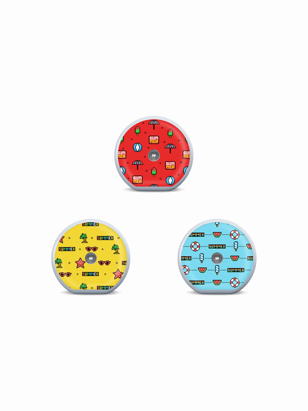 Three Accu-Chek SmartGuide sensor stickers in red, yellow and blue pixel-art designs with playful summer icons.