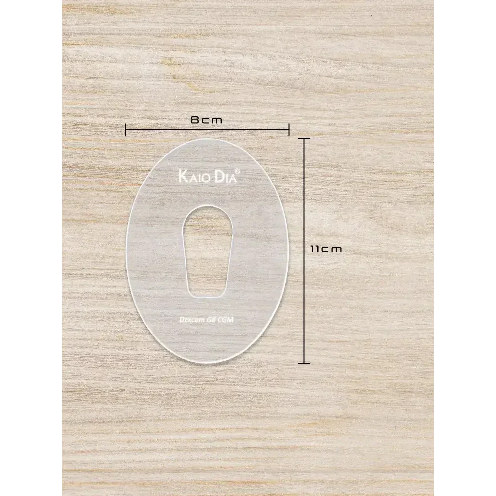 Kaio-Patch Template for CGM sensor patch on a wooden surface, dimensions labeled 8cm by 11cm.