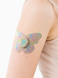 Plaster til Dexcom G7, form: sommerfugl, på armen, nærbillede