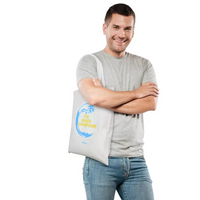Diabetes awareness bag with T1D Beach Champions design from Kaio-Tote Summer 2024, modeled by a person standing with crossed arms.