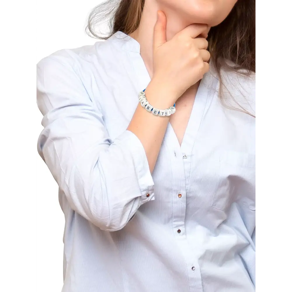 Diabetic bracelet on a woman's wrist, symbolizing diabetes awareness and support.