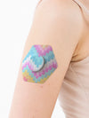 FreeStyle Libre 2 hexagonal shape patch close-up on arm, showing breathable adhesive support around the sensor