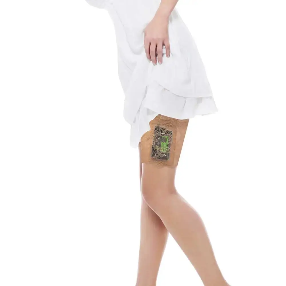 Woman wearing a Dia-Lacy lace garter on thigh securely holding an insulin pump under a white dress