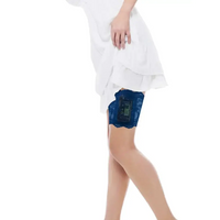 Woman wearing blue lace garter for insulin pump under white dress lifting hem to show device holder