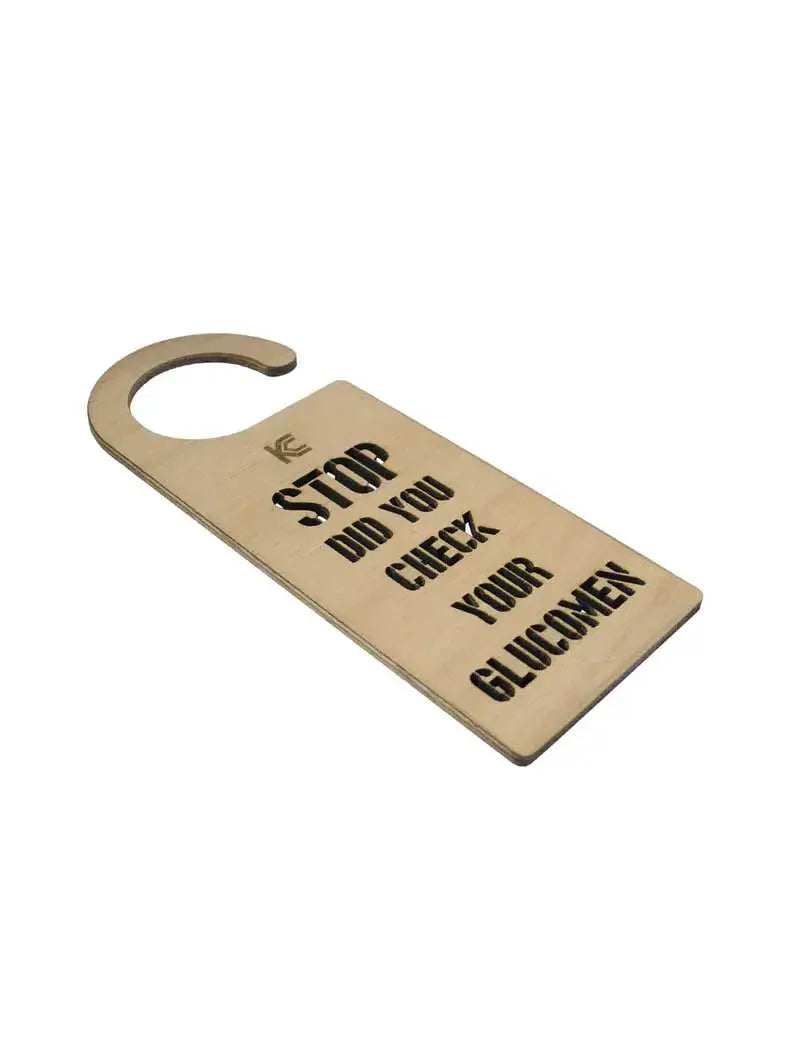 Door hanger reminding diabetics to check glucose levels, made from light plywood.